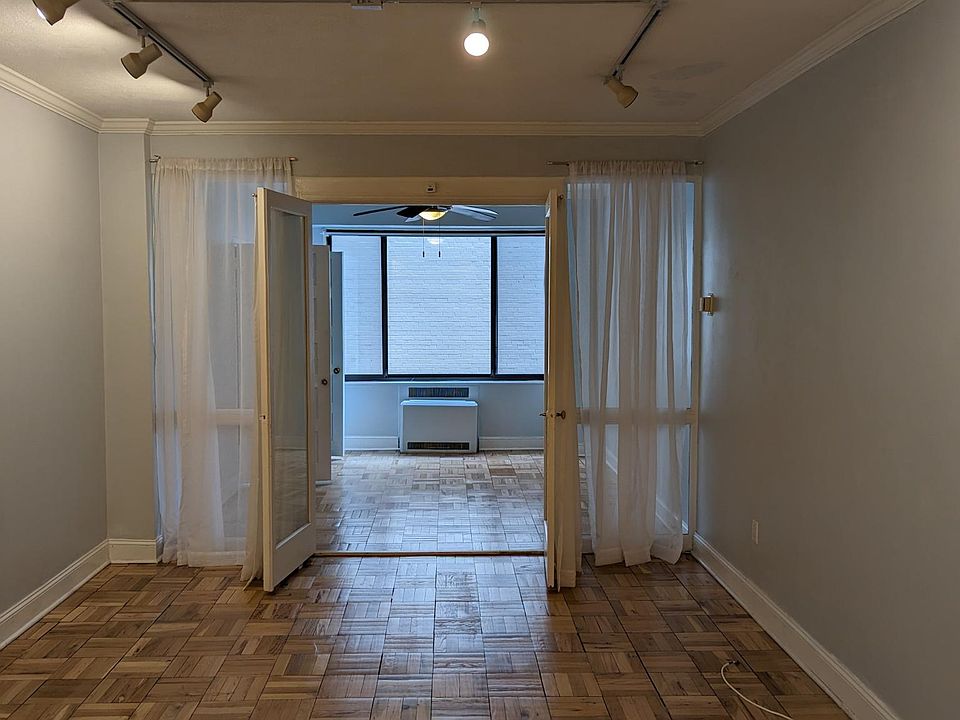 View from kitchen through living room and into bedroom.