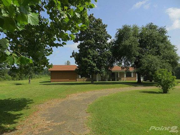 Home sits back from the road with circle drive and well established trees and shrubbery. Home for sale country Harris Community.