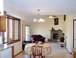 Kitchen opens to Family Room with Vaulted Ceilings and Fireplace