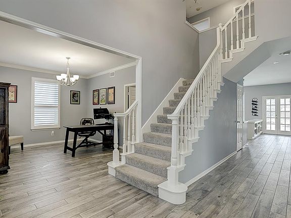 Upon entry you will notice the neutral paint, wood look tile flooring, and formal dining currently being used as an office.