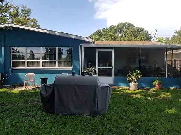 Grill and porch in backyard.