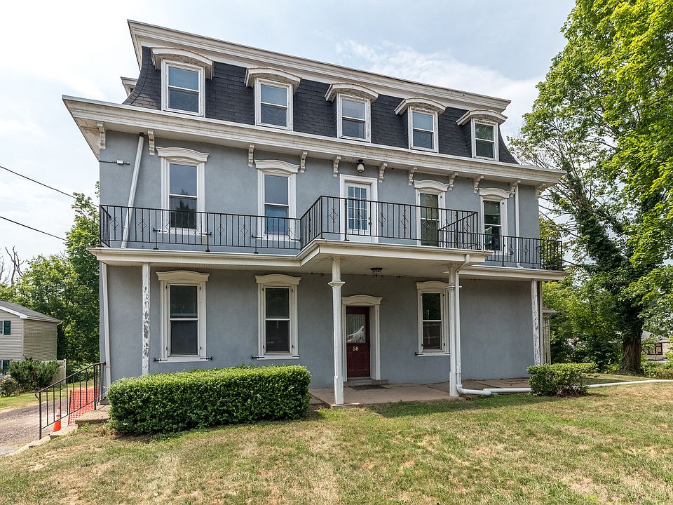 Tucked behind this vintage "circa 1860 grand gray lady" is a newer building that houses the apartment for rent. This building faces the street and offers additional condos for rent.
