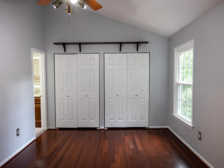 Master bedroom with his and her closets.