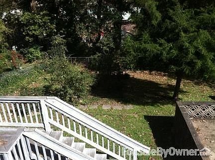 Porch overlooking fenced-in backyard