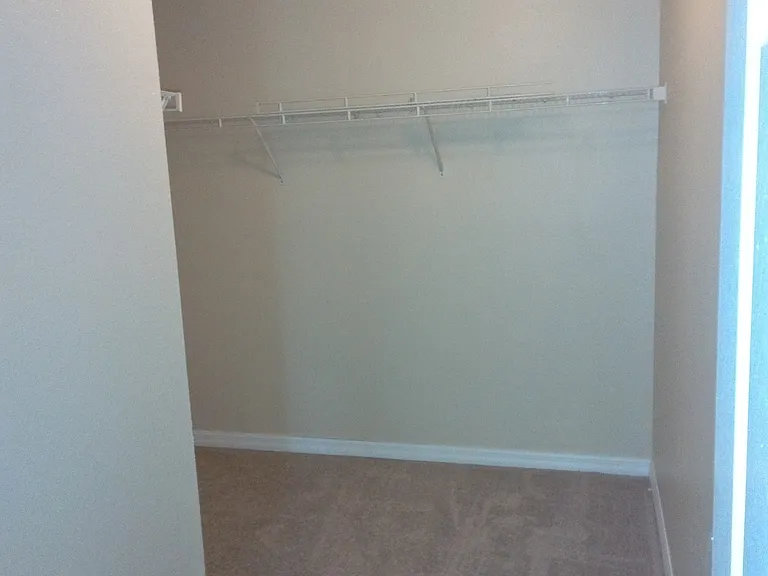 This walk-in closet is larger than some bedrooms.
