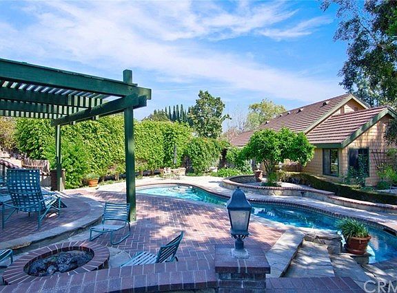 Sparkling pool & spa is nestled amongst lush landscaping!