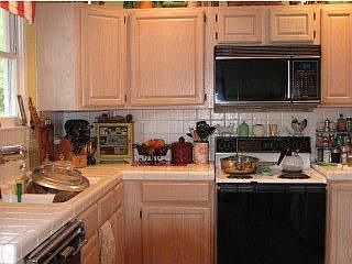 oak cabinets, tile counters
