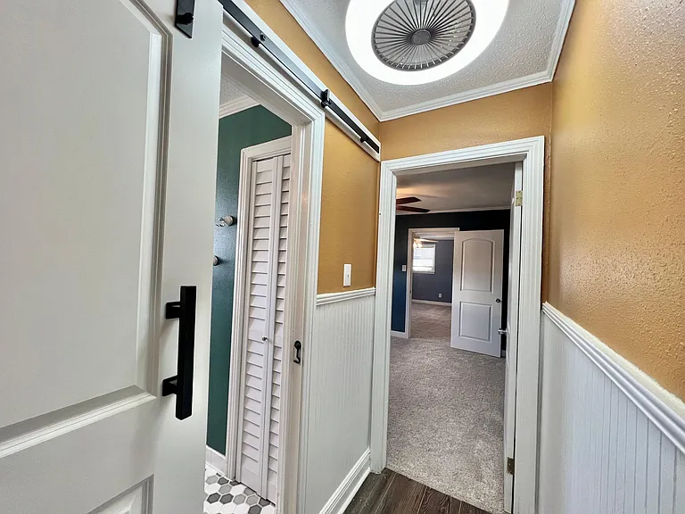 Hall access to full shower/tub combination bathroom. Specialty tiles, pedestal vanity and storage.