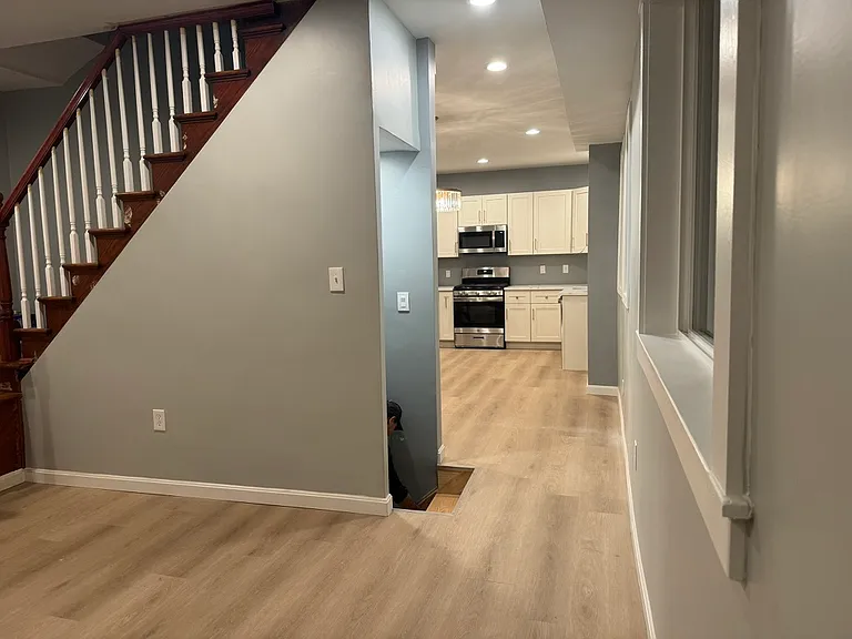 living room view towards open dining and kitchen