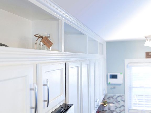 View of open shelves above cabinets