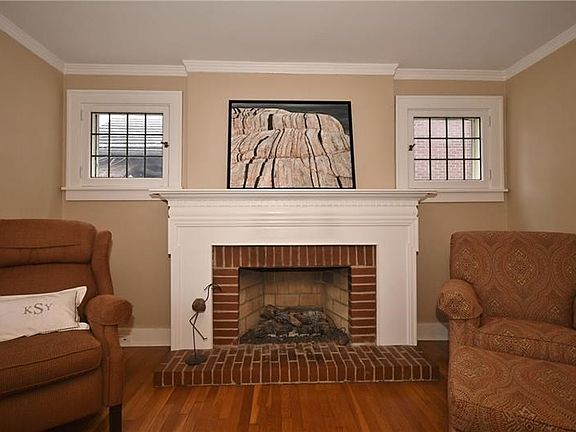 Gorgeous gas fireplace is flanked by lead glass windows