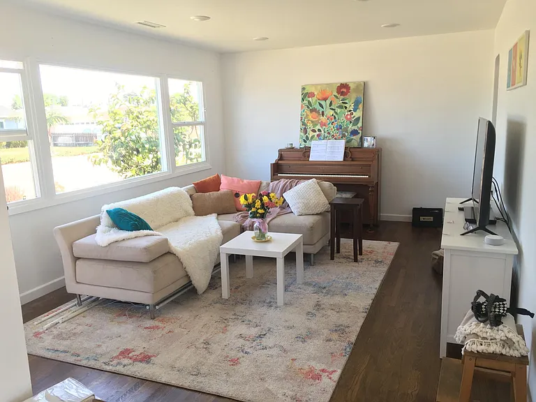 Living room with large picture window and recessed lighting