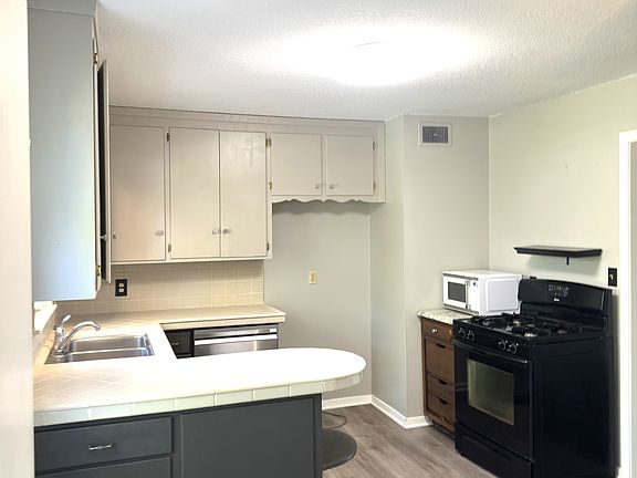 Large eat in kitchen with table area to left- standing in Laundry/mud room entry