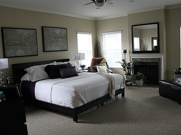 Large master suite with recess lighting. Fireplace has marble hearth and crown molding.