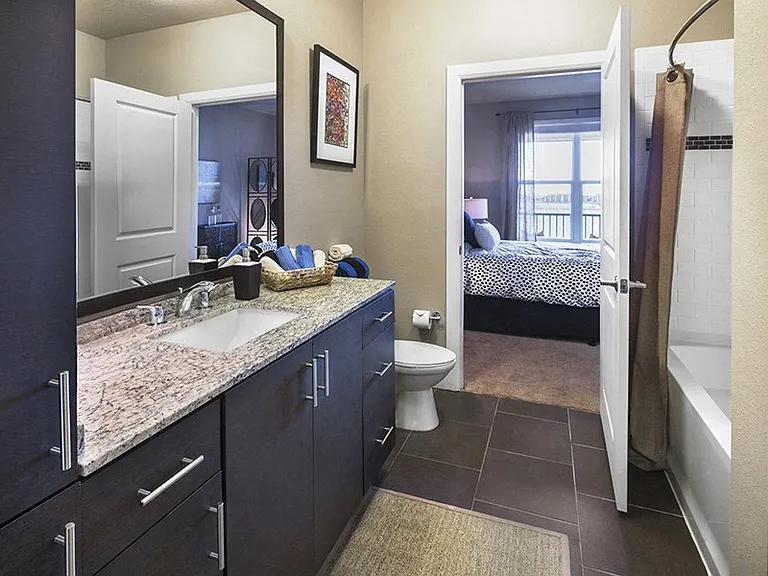 Our modern bathrooms include framed mirrors and tile surround