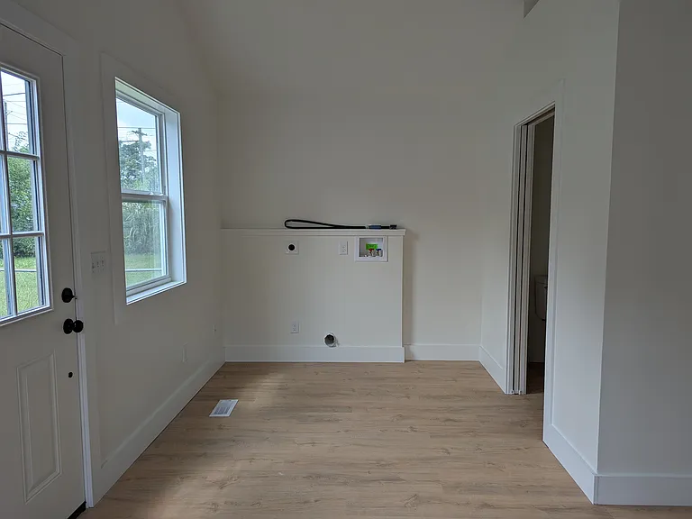 Laundry area by half bath and dining - unfurnished