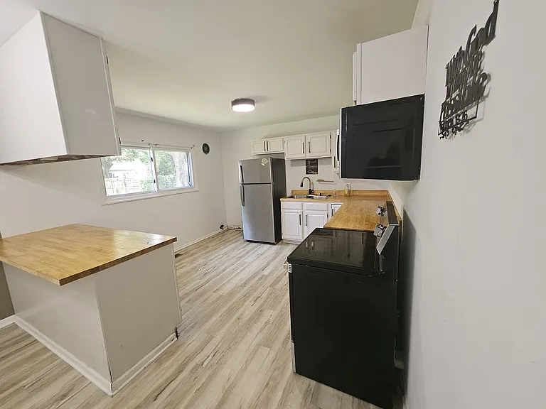 Kitchen - newly updated, dishwasher, stove, oven, refrigerator, microwave, & laundry hookups.