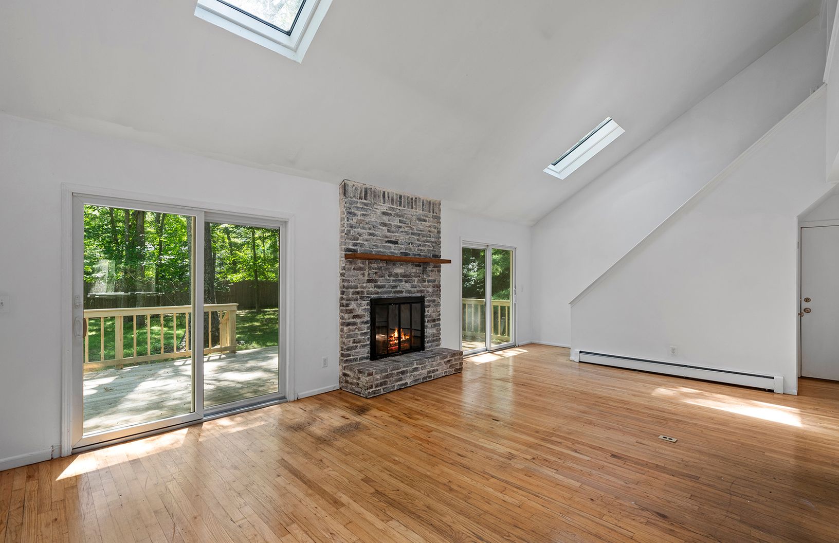  Vaulted Living room with skylights and fireplace