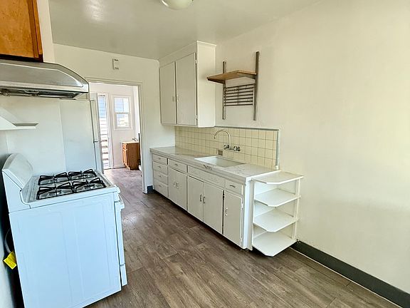 Kitchen with brand new counter top, refrigerator and brand new stove/oven.