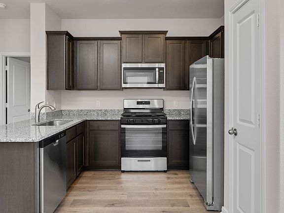 The kitchen has energy-efficient, stainless-steel appliances.