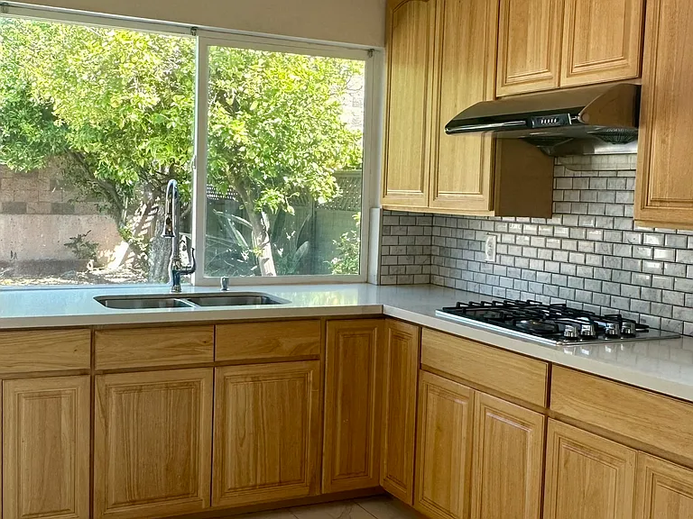 Kitchen with windows overlooking the backyard