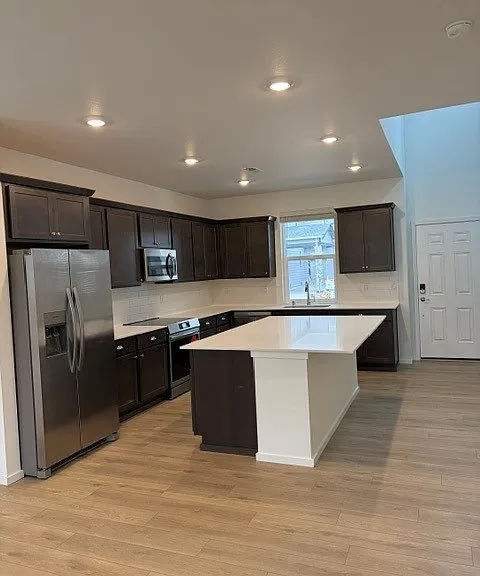 Quartz counters, large island, induction oven, microwave, dishwasher, garbage disposal, tons of quiet close cabinets.