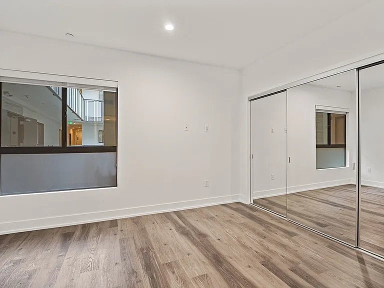 Bedroom with Large-Size Mirrored Closets