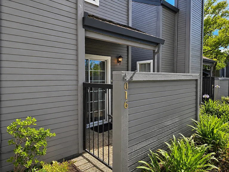 Private gated courtyard provides a welcoming second outdoor living space with direct access to guest parking for added convenience.