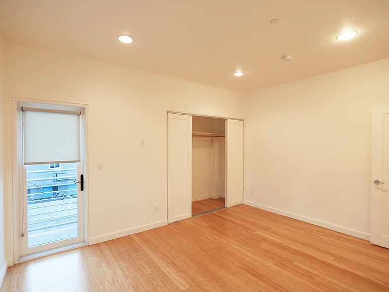 31. Rear Bedroom Balcony and Closet Doors Looking West