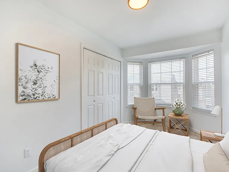A bright bedroom with large windows and oversized closet is shown at ReNew on Cantrell.