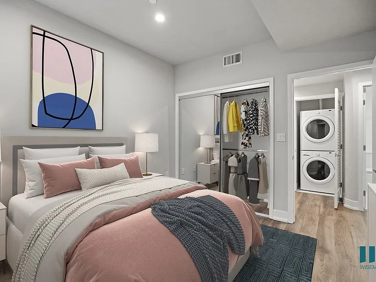 Bedroom with Mirrored Closet and In-Suite Washer & Dryer in Hallway