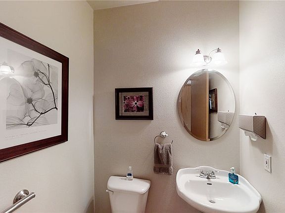 Half bath downstairs with pedestal sink.