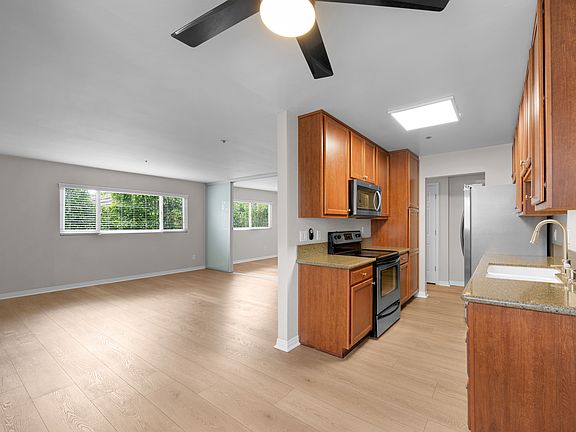View from Dinette Area Into Living, Kitchen and Den.