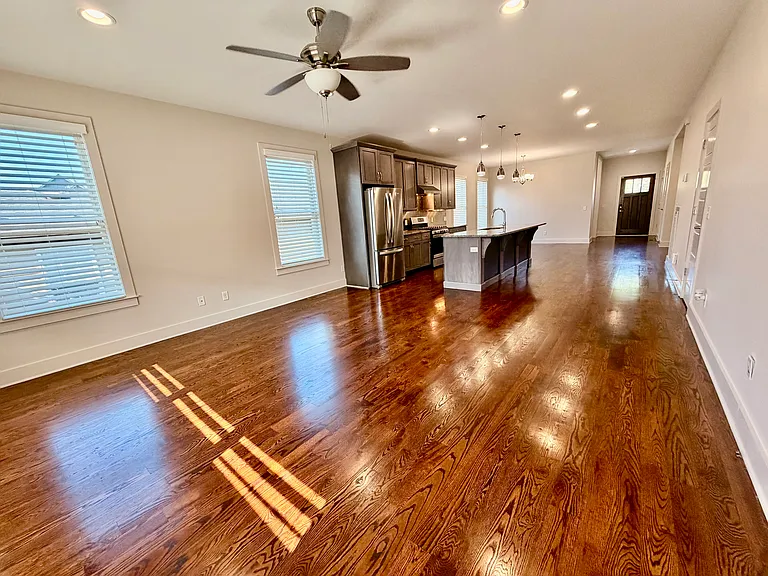 The living room area opens to the kitchen and dining room