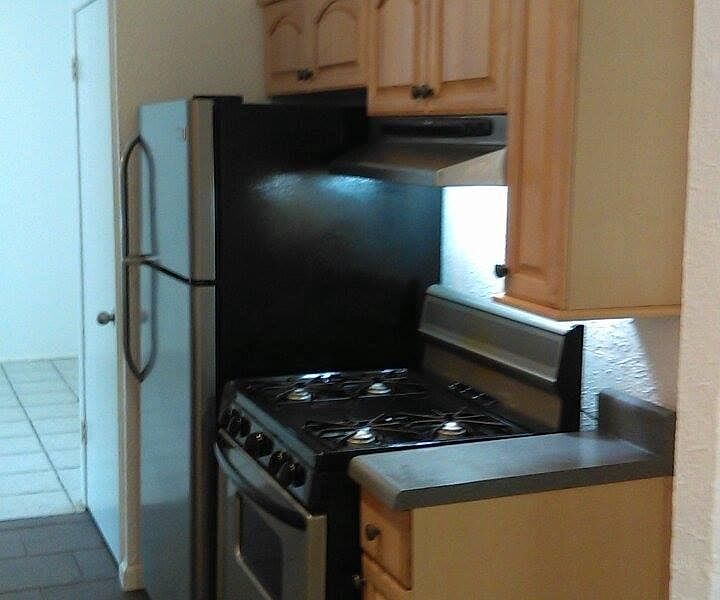 In this kitchen there is a gas oven/stove and the refrigerat