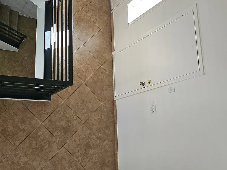 View from upper level showcasing the main entry, direct garage access, and convenient layout including guest bathroom and entry closet.