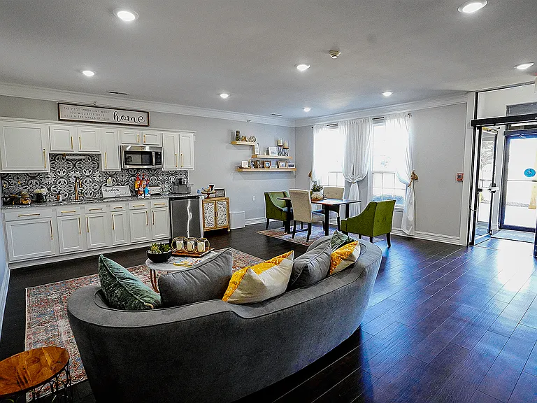 Clean lines, soft lighting, and a kitchenette make this space feel like an extension of your apartment, but with more room for friends.