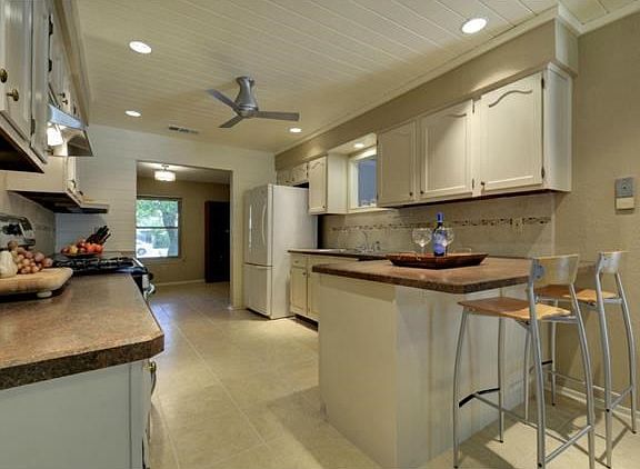 The kitchen has a breakfast bar for additional dining space.