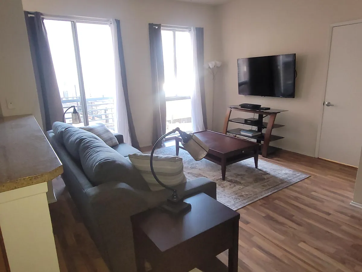 Photo 2 of 14 - 445 Island Ave #408 - San Diego, CA Living Room with wonderful natural light overlooking the courtyard and pool - 445 Island Ave #408