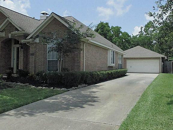 Long driveway along side of home to detached two car garage.
