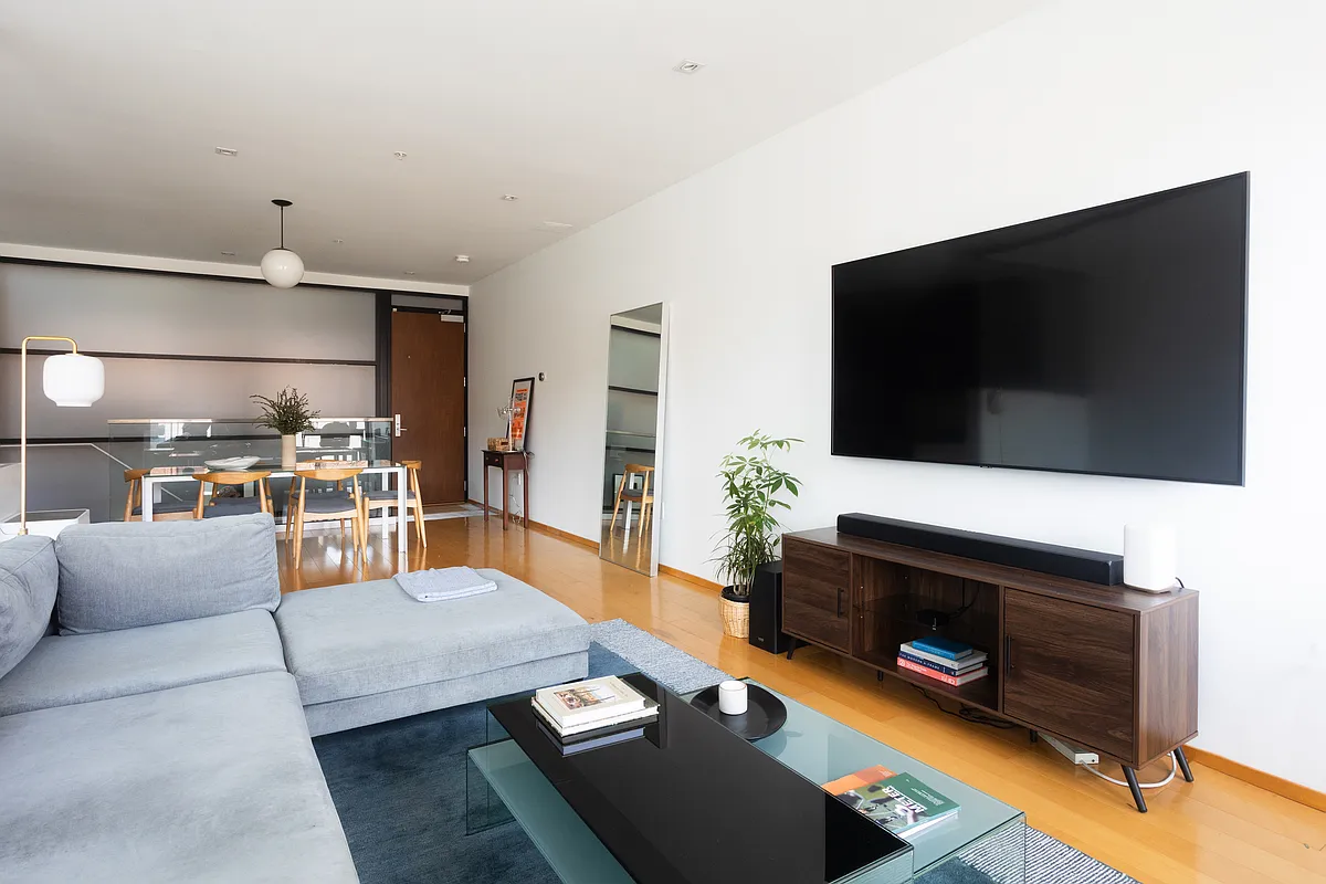 Photo 2 of 38 - 2250 11th St NW #103 - Washington, DC Upon entering, main living space with wall-mounted TV and soundbar. - 2250 11th St NW #103