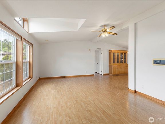 Large living room with lots of natural light and vaulted ceiling>
