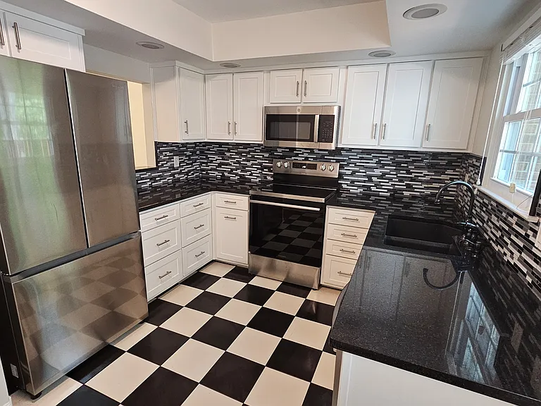 Brand new kitchen appliances (refrigerator, oven range, dishwasher, microwave).