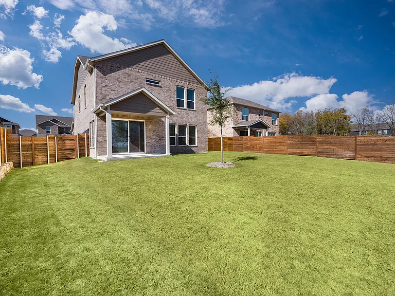 A spacious fenced backyard offers room to relax, play, or gather, extending everyday living into a private outdoor setting behind the home.
