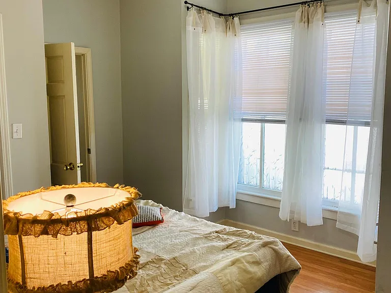 The Second bedroom's Bay windows and the door to the attached First bathroom