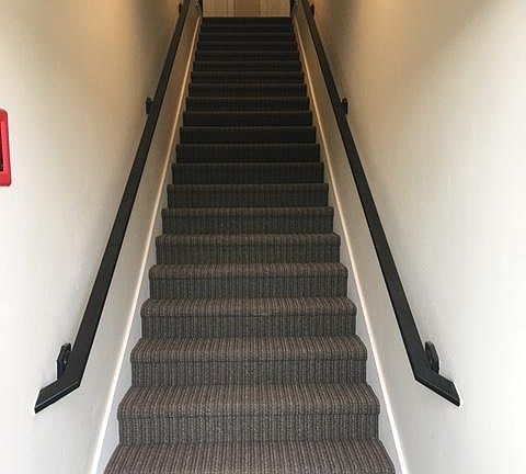 Interior stairs going up to the four apartments upstairs.