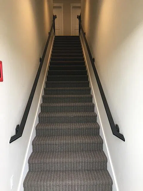 Interior stairs going up to the four apartments upstairs.