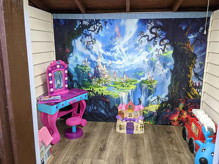 Inside the outdoor playhouse for little ones. Best for 8 year olds and below.