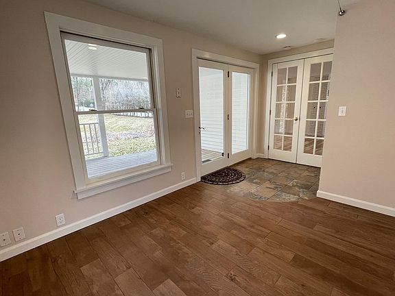 Porch entrance into hall with closet and family room.