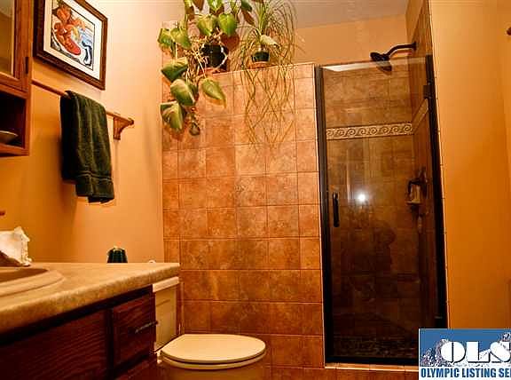 Guest bath has a walk in shower newly tiled and brightly lit up from the skylight overhead.